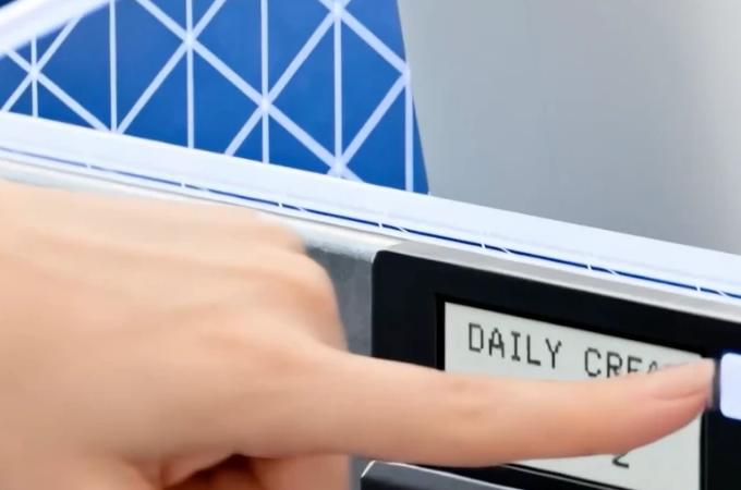Close-up of a hand selecting the illuminated button on a LIORA shelf display