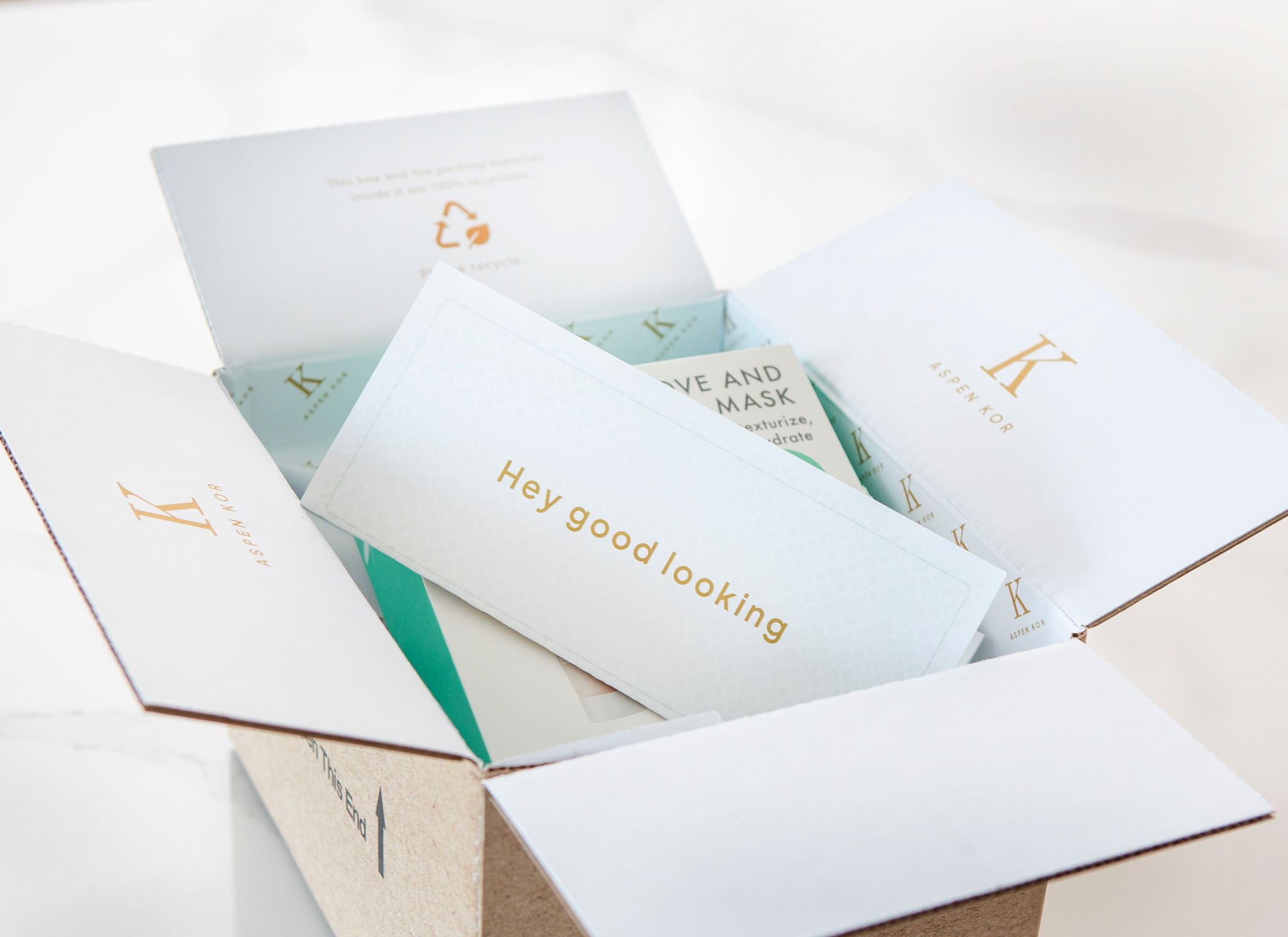 An open cardboard parcel with printed inserts and packaged products